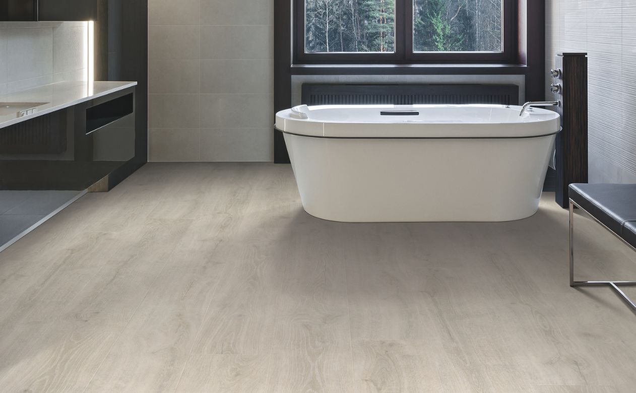 Bathroom with laminate flooring and a freestanding tub